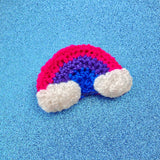 Bisexual Pride Flag inspired crochet rainbow hair clip with white clouds on the ends of the rainbow. Bisexual Rainbow Cloud Hair Clip by VelvetVolcano