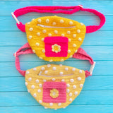 Two yellow and pink crochet bum bags with polka dot and flower designs by VelvetVolcano