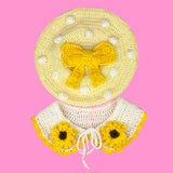 Pastel yellow crocheted beret with cream polka dots and a large buttercup yellow bow in the centre and a cream Peter Pan style collar with yellow scallop trim and sunflower applique design by VelvetVolcano