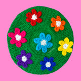 Grass green crochet beret with daisy design, each flower a different rainbow colour. Bright Rainbow Daisy Daze Beret by VelvetVolcano