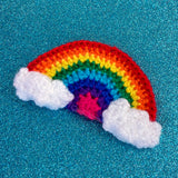 Crochet rainbow hair clip with white clouds at both ends of the rainbow - Bright Rainbow Cloud Hair Clip by VelvetVolcano