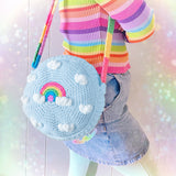 VelvetVolcano Circular Crochet Shoulder Bag in Duck Egg Blue with White Cloud and Pastel Rainbow Design and Pastel Rainbow Striped Strap