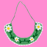 A light green crocheted Peter Pan collar with a white scalloped trim and a repeating daisy chain design on the main part of the collar by VelvetVolcano