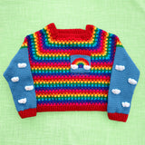 Cropped Crochet Bright Rainbow Cloud Jumper / Sweater with grey blue sleeves that have a white cloud pattern and red cuffs and a chest pocket with a rainbow and white clouds by VelvetVolcano