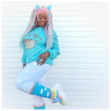 AyeshaShaSha wears VelvetVolcano Kawaii Turquoise Crochet Leg Warmers with White Cloud Pattern and Pastel Rainbow Striped Cuffs