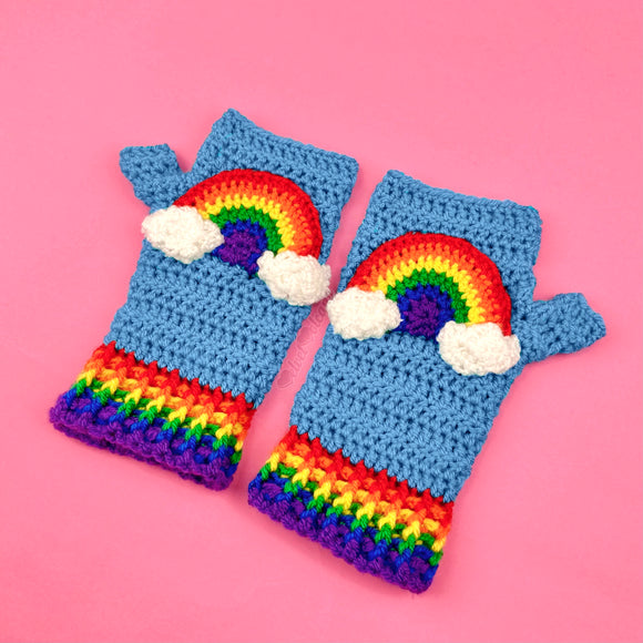 Dolphin Blue crocheted fingerless gloves with rainbow cloud motifs on the front of the gloves and rainbow striped cuffs by VelvetVolcano 