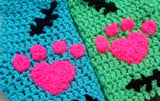 FrankenKitty Mittens by VelvetVolcano. One mitten is Turquoise and the other is Neon Green and they feature either Neon Pink or Black cuffs, black embroidered stitch designs and neon pink heart shaped paw prints.