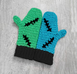 FrankenKitty Mittens by VelvetVolcano. One mitten is Turquoise and the other is Neon Green and they feature either Neon Pink or Black cuffs, black embroidered stitch designs and neon pink heart shaped paw prints.
