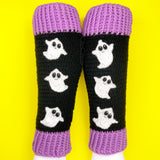 Black crochet leg warmers with a column of white ghosts with cute smiley faces and lilac ribbed cuffs. - VelvetVolcano Acrylic Crochet Spooky Ghost Leg Warmers