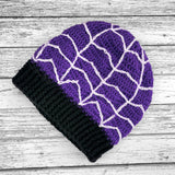 Purple slouchy crochet beanie with white spider web / cobweb design and black ribbed brim by VelvetVolcano