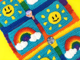 Sunshine & Rainbows Hanging Organiser - Colourful Rainbow Striped Crochet Wall Art with Sun and Rainbow Cloud Pockets and Pom Pom Trim by VelvetVolcano