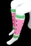 A pair of bubblegum pink crochet leg warmers designed to look like watermelon with white and pastel green cuffs for the rind and sewn on black rhinestone seeds. Custom Colour Watermelon Leg Warmers by VelvetVolcano