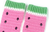 A pair of bubblegum pink crochet leg warmers designed to look like watermelon with white and pastel green cuffs for the rind and sewn on black rhinestone seeds. Custom Colour Watermelon Leg Warmers by VelvetVolcano