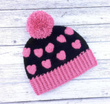 Bubblegum Pastel Pink & Black Heart Print Pom Pom Acrylic Crochet Beanie by VelvetVolcano