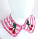 Bubblegum pink and white striped Peter Pan style detachable crochet collar with red and green cherry appliques on the lapels of the collar and a pink heart shaped button fastening. Cherry Stripe Collar by VelvetVolcano