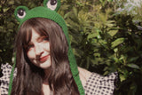 Kara wearing the Frog Earflap Beanie in Forest