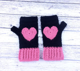 Black crochet hand warmers with bubblegum pink heart design and bubblegum pink cuffs. Heart Fingerless Gloves by VelvetVolcano