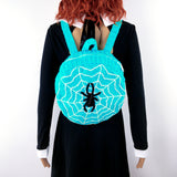 Turquoise, White & Black circular shaped crochet backpack with spider web design. 