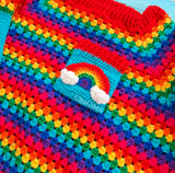 Bright Rainbow striped crocheted cropped jumper with Turquoise sleeves with White cloud applique pattern and a chest pocket with a rainbow and cloud motif by VelvetVolcano