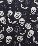 Black fabric with white print of pumpkins, skulls, bats, spider webs and stars