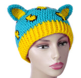 Turquoise crochet cat ear hat with buttercup yellow inner ears and bottom rib and buttercup yellow and black leopard print on the turquoise main part of the hat. Leopard Kitty Beanie (Custom Colour) by VelvetVolcano