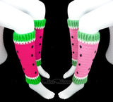 Two pairs of crochet leg warmers designed to look like watermelon with pink (one is neon pink, the other is bubblegum pink) main colour for the fruit and white and green cuffs for the rind (the neon pink has neon green rind and the bubblegum pink has pastel green rind). They also feature black rhinestone seeds. Custom Colour Watermelon Leg Warmers by VelvetVolcano