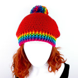 Rose Red slouchy crochet bobble hat with rainbow pom pom and rainbow striped brim by VelvetVolcano