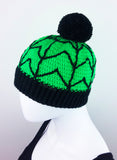 Neon Green crochet bobble hat with black cobweb design and black pom pom and bottom rib. Spider Web Pom Pom Beanie (Custom Colour) by VelvetVolcano